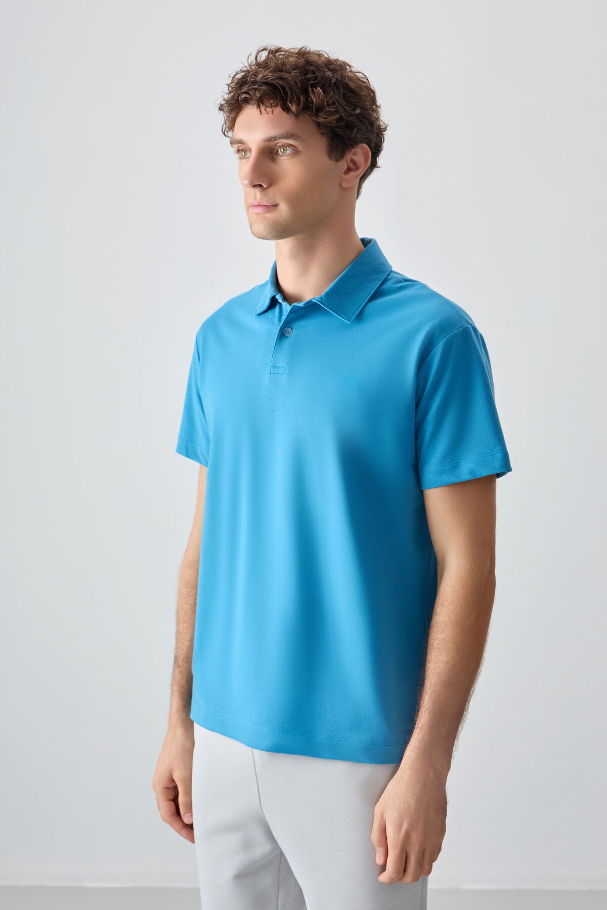 Image of Tricou bărbătesc albastru-petrol, gros, texturat, cu guler polo, croială supradimensionată, stil basic - 88381