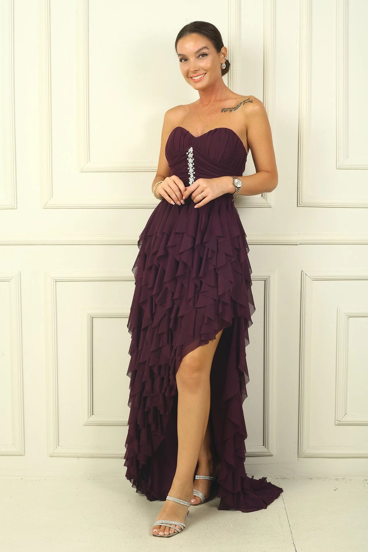 Image of Strapless, long tulle dress with stone detailing at the front, draped, lined, and with side slits and ruffles.