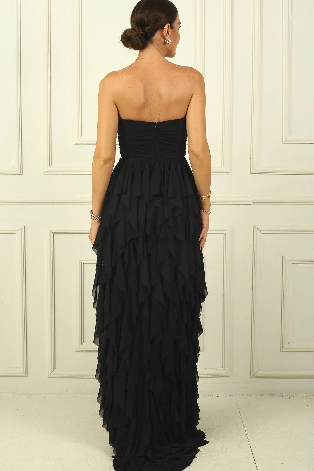 Image of Strapless, long tulle dress with stone detailing at the front, draped, lined, and with side slits and ruffles.