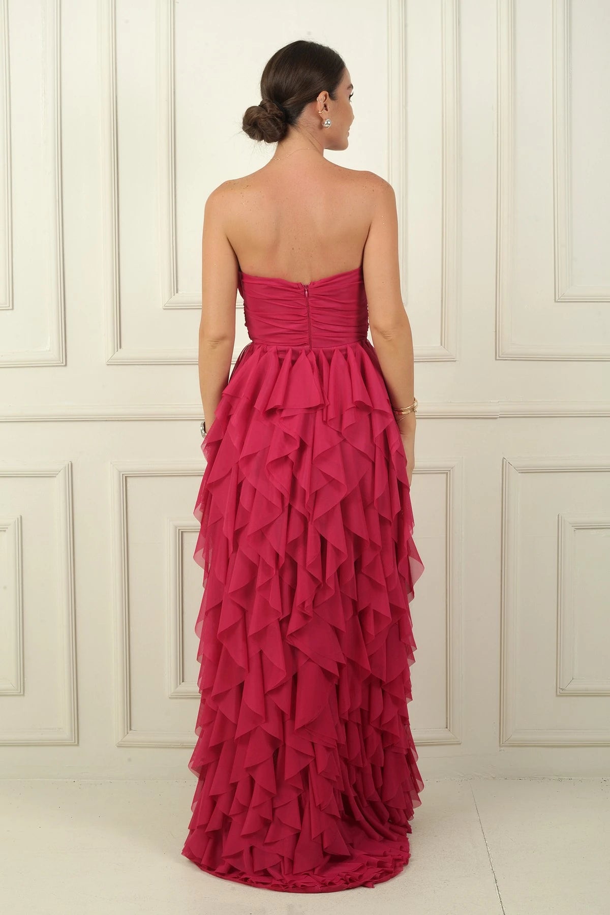 Image of Strapless, long tulle dress with stone detailing at the front, draped, lined, and with side slits and ruffles.