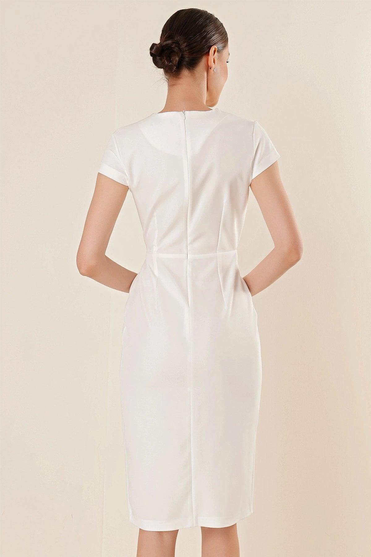 Image of Wrap-neck, half-moon sleeve dress with stone details and front slit.