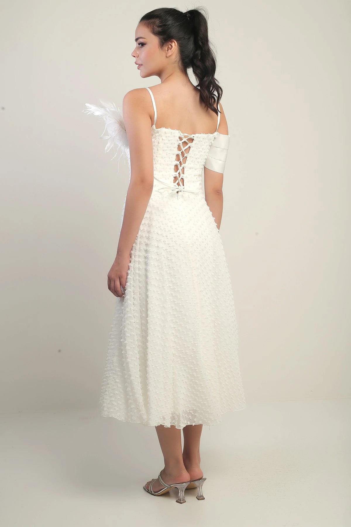 Image of Women's Strappy, Back Lace-Up, Dropped One-Sleeve Dress with Feather Brooch, Lined, and Glossy Fabric.