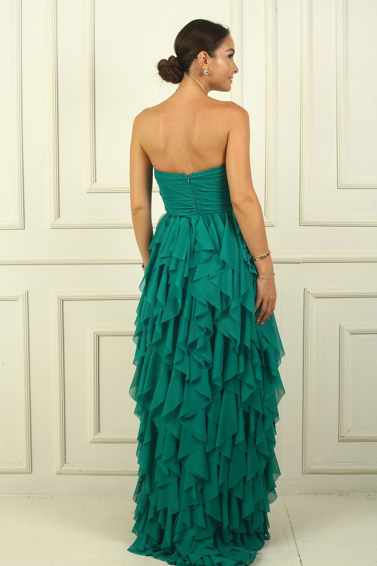 Image of Strapless, long tulle dress with stone detailing at the front, draped, lined, and with side slits and ruffles.