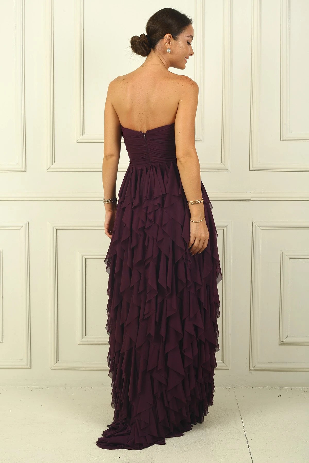 Image of Strapless, long tulle dress with stone detailing at the front, draped, lined, and with side slits and ruffles.