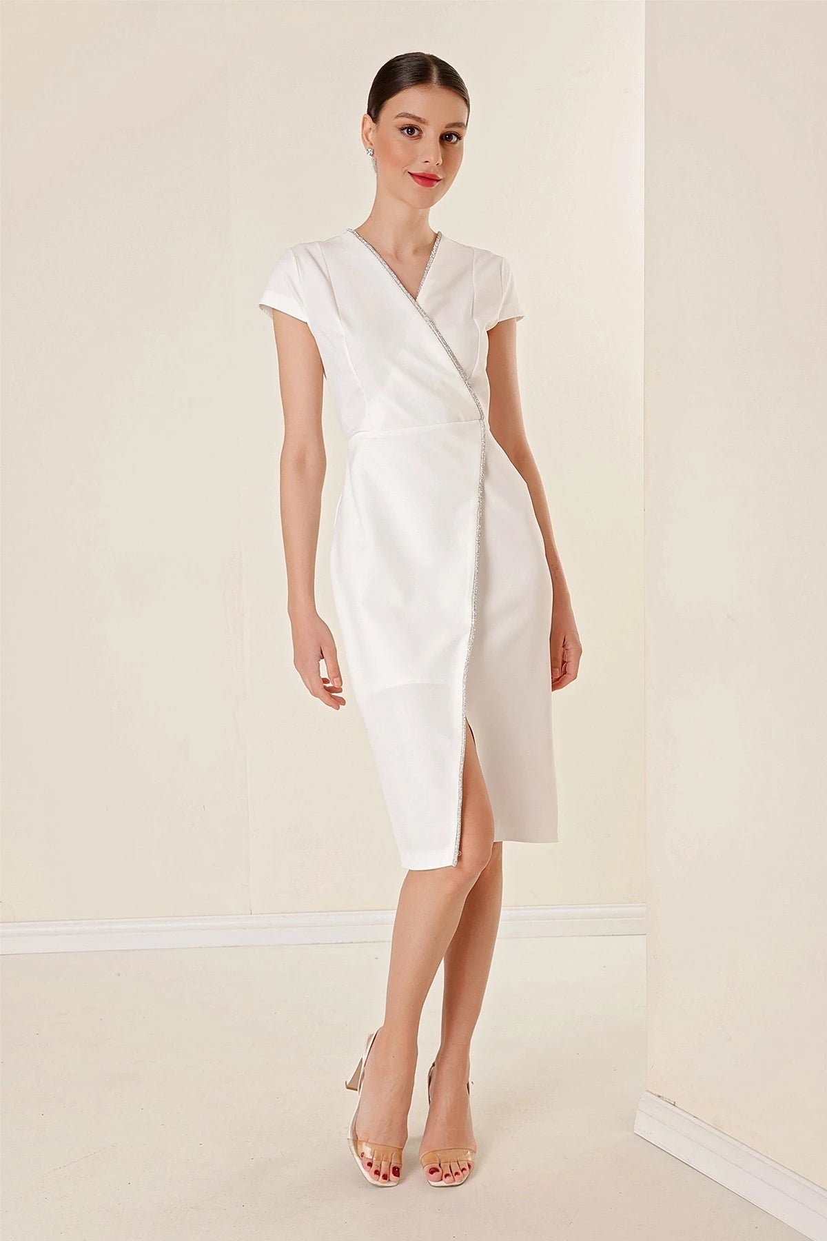 Image of Wrap-neck, half-moon sleeve dress with stone details and front slit.