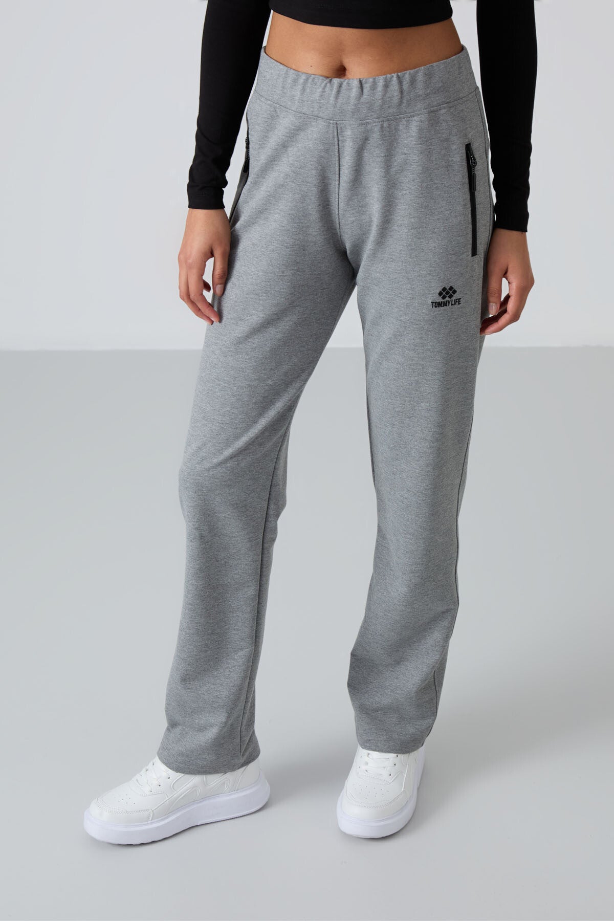 Image of Pantaloni de trening gri melanj pentru femei cu buzunare cu fermoar, croială confortabilă, model clasic pe picior - 94195